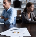 couple sitting at table with divorce documents
