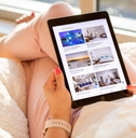 Woman holding iPad with Airbnb listings