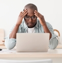 Worried man looking at computer