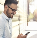 Smiling man looking at phone