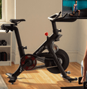 Woman working out at home with a Peloton bike