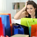 worried shopaholic woman after multiple purchases 