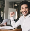 successful man rejoicing and clenching fists 