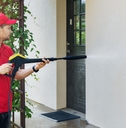 Man pressure washing a building