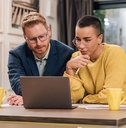 mixed races couple sitting in living room discussing