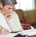 senior woman working on her bills