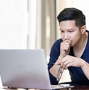 confident asian young freelancer in smart casual working