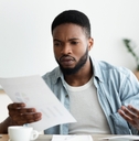 Man looking at bills