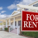 for rent real estate sign in front of house