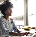 young woman working on computer at home