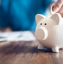 piggy bank with a coin placed in it