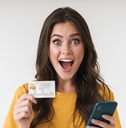 Happy woman holding credit card