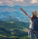 traveler girl standing with raised arms