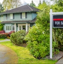 house for sale real estate sign in front of a house