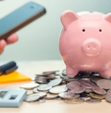 piggy bank on top of coins