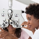 optometrist doing sight testing for patient