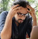 man stressed on laptop