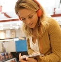 woman in multimedia store testing new music discs
