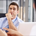 skeptical interviewer looking at interviewee