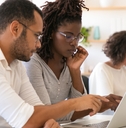 Instructor explaining corporate software specific to intern