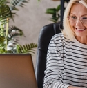 beautiful elderly businesswoman speaking on smart phone while working