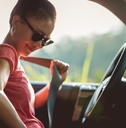 Woman driver buckle up the seat belt before driving car