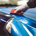 car wrapping specialist putting vinyl foil or film on car
