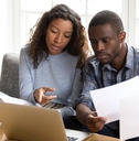 African American couple discussing about paper documents