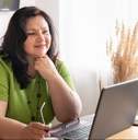 woman in the office sitting at a desk with a laptop