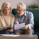 Serious mature couple calculating bills
