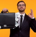 man wearing glasses and holding a money bag
