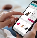 Woman shopping online via smartphone indoors