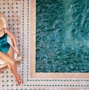 woman on the sun lounger near the private swimming pool 