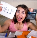 worried woman calculating monthly expenses and debt