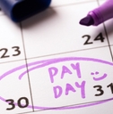 payday concept calendar with marker and circled day of salary