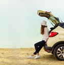 woman waiting by her car looking at an open space