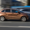 brown car Lada Xray riding at the city street