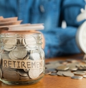 Jar of coins labeled for retirement