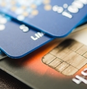 A stack of multicolored credit cards.