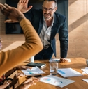 two men high-fiving during a meeting