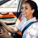 Woman smiling and driving