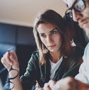 a man and a woman studying on a laptop
