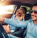 Happy couple driving