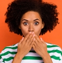 attractive puzzled wavy-haired girl closing mouth oops 