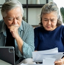 asian senior couple checking and calculate financial billing together