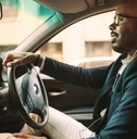 Man driving with headphones in