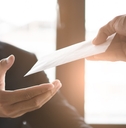office worker receiving extra money from boss as a reward 