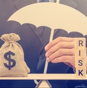 businessman holds a white umbrella protects a dollar bag on basic balance scale
