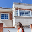 woman inspector checking house at construction site