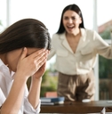 boss screaming at employee in office